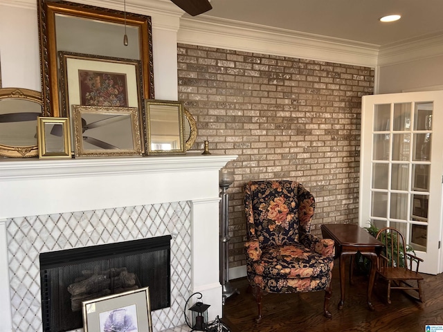 room details featuring recessed lighting, ornamental molding, and a tile fireplace