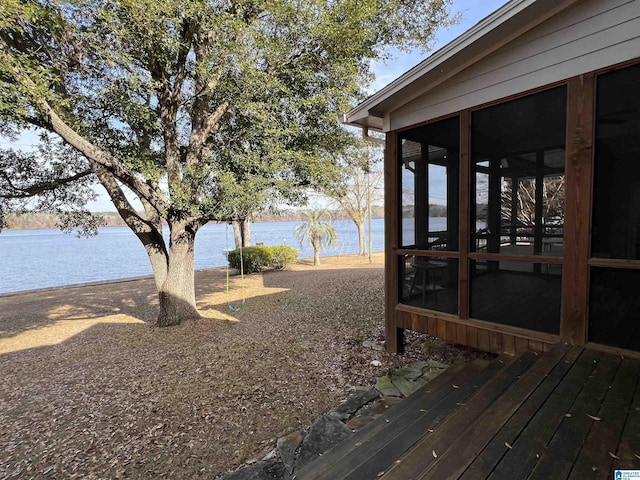 view of yard with a water view and a sunroom