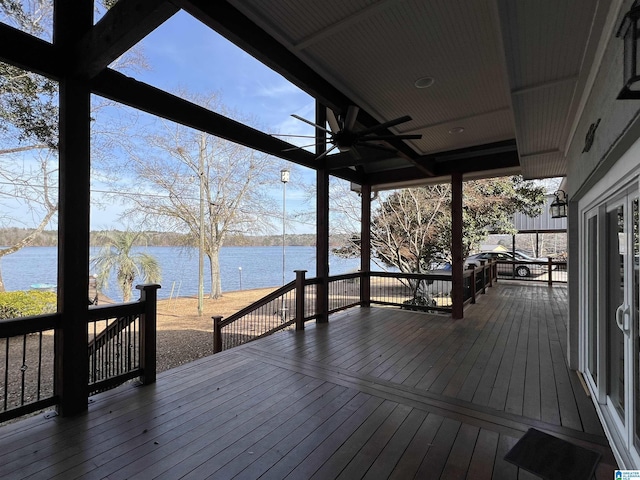 wooden terrace with a water view and a ceiling fan