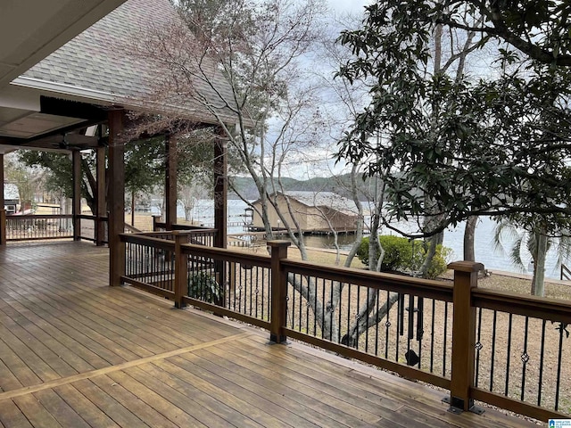 wooden terrace featuring a water view