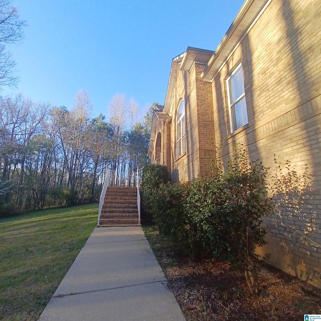 7459 15th Street Rd, Bessemer, AL 35023 - view of property exterior with stairs, a yard, and brick siding