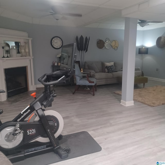 7459 15th Street Rd, Bessemer, AL 35023 - exercise area featuring a ceiling fan, a drop ceiling, wood finished floors, a fireplace, and baseboards
