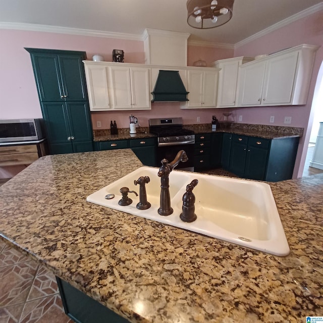 7459 15th Street Rd, Bessemer, AL 35023 - kitchen with premium range hood, a sink, ornamental molding, appliances with stainless steel finishes, and white cabinetry