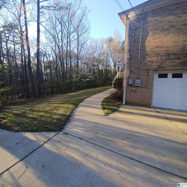 7459 15th Street Rd, Bessemer, AL 35023 - view of side of home featuring brick siding, concrete driveway, and a garage