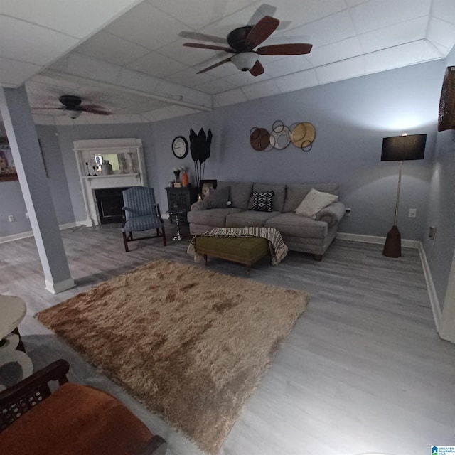 7459 15th Street Rd, Bessemer, AL 35023 - living area with baseboards, a paneled ceiling, a ceiling fan, and wood finished floors
