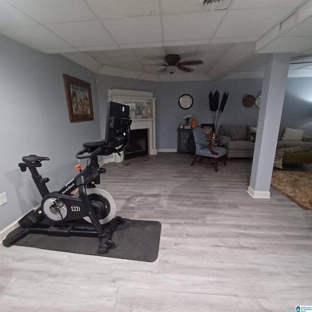 7459 15th Street Rd, Bessemer, AL 35023 - workout room with a ceiling fan, wood finished floors, baseboards, a fireplace, and a drop ceiling