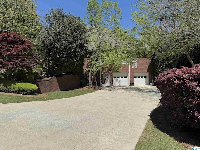 view of side of property featuring concrete driveway