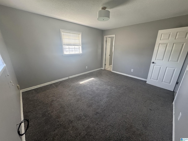 1804 Ragsdale Rd, Cullman, AL 35055 - unfurnished bedroom featuring dark colored carpet, baseboards, and a textured ceiling