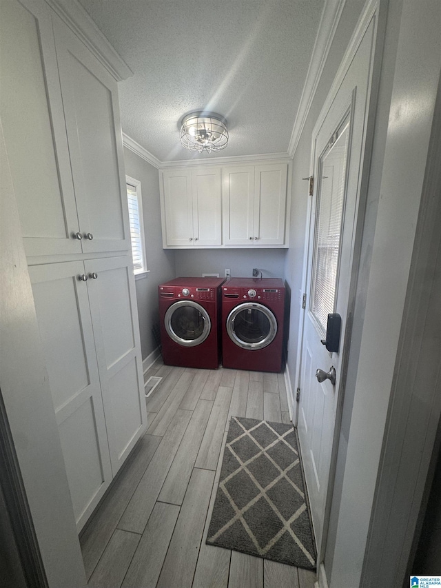 1804 Ragsdale Rd, Cullman, AL 35055 - clothes washing area featuring wood finish floors, cabinet space, a textured ceiling, crown molding, and independent washer and dryer