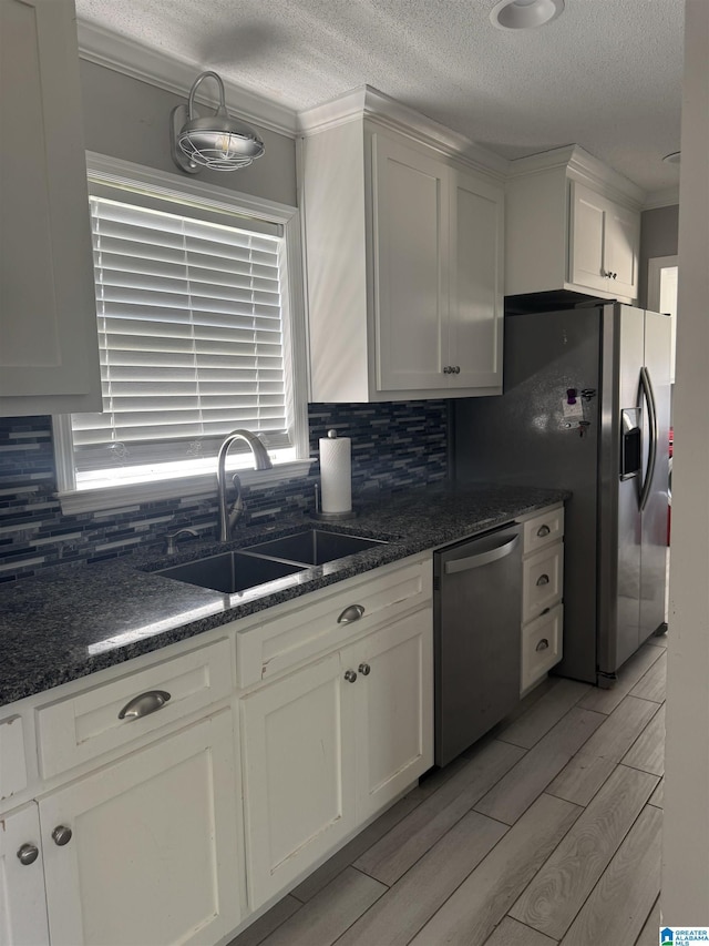 1804 Ragsdale Rd, Cullman, AL 35055 - kitchen featuring wood tiled floor, a sink, white cabinets, appliances with stainless steel finishes, and backsplash