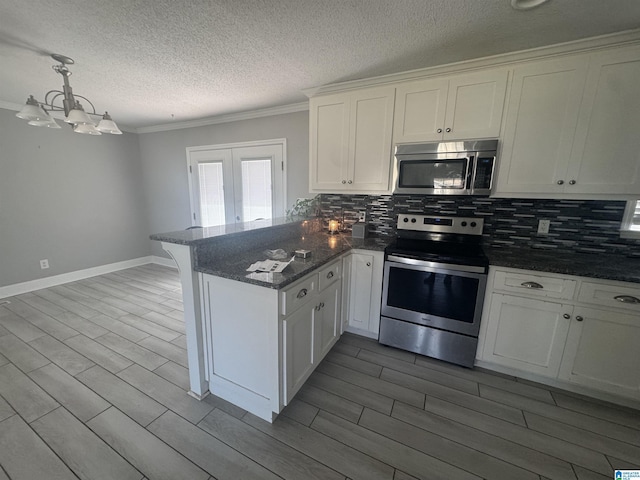 1804 Ragsdale Rd, Cullman, AL 35055 - kitchen featuring backsplash, wood tiled floor, a peninsula, stainless steel appliances, and white cabinetry