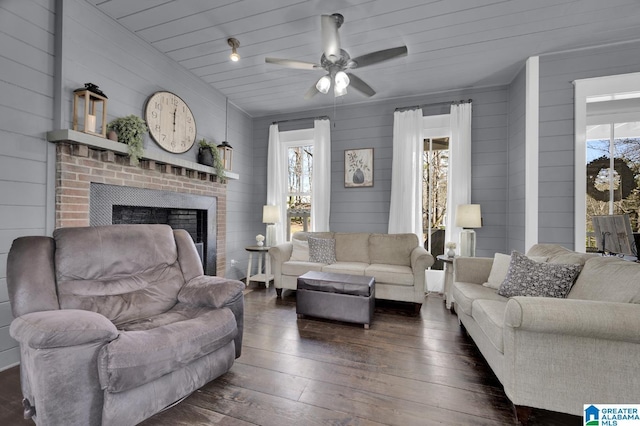 living room featuring a healthy amount of sunlight, a fireplace, and hardwood / wood-style flooring