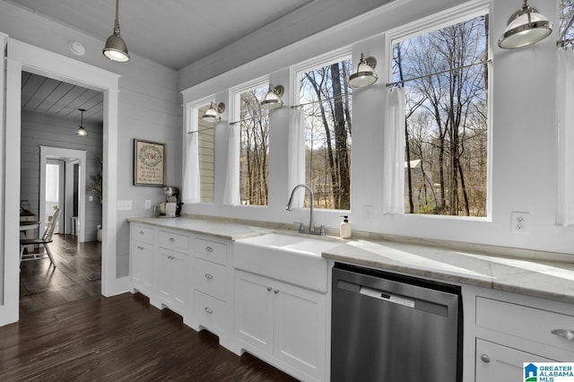 interior space with light stone counters, a sink, dark wood-type flooring, white cabinets, and stainless steel dishwasher