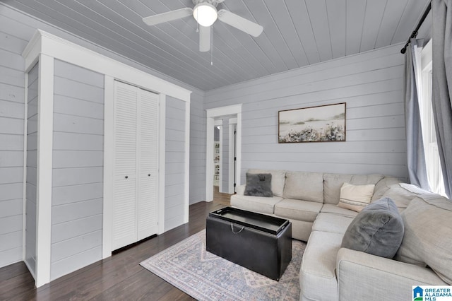 living area featuring wood ceiling, a ceiling fan, and dark wood-style flooring