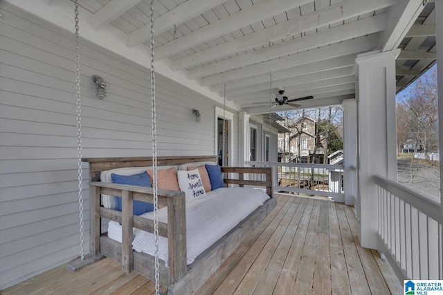 deck featuring covered porch and a ceiling fan