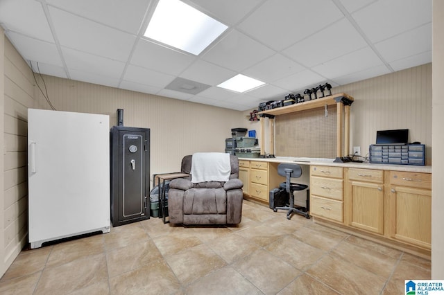 office area with a paneled ceiling
