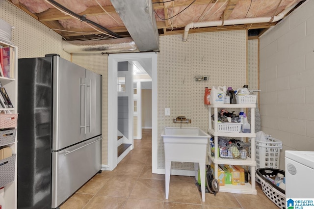interior space with tile patterned flooring and high end fridge