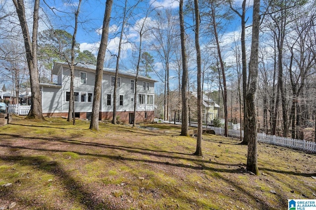 view of front of property with a front lawn and fence