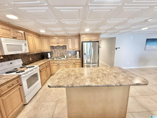 360 Frankies Rd, Vincent, AL 35178 - kitchen featuring an ornate ceiling, backsplash, light stone countertops, a center island, and white appliances
