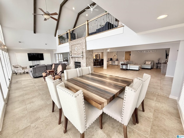 360 Frankies Rd, Vincent, AL 35178 - dining room with a brick fireplace, crown molding, high vaulted ceiling, visible vents, and a ceiling fan