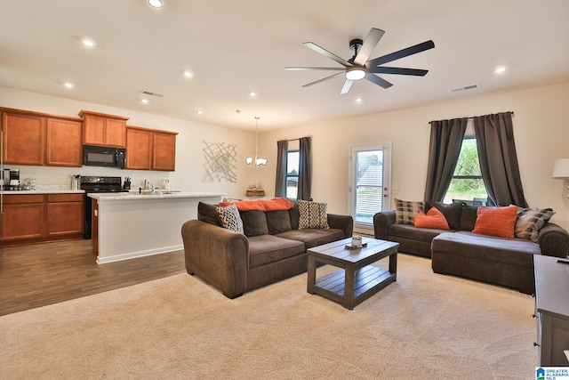living room with wood finished floors, recessed lighting, visible vents, and ceiling fan