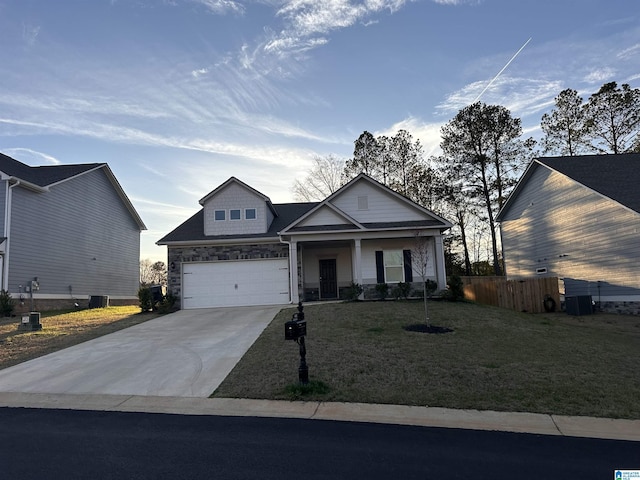 view of front of home featuring central air condition unit, a garage, concrete driveway, a front lawn, and covered porch