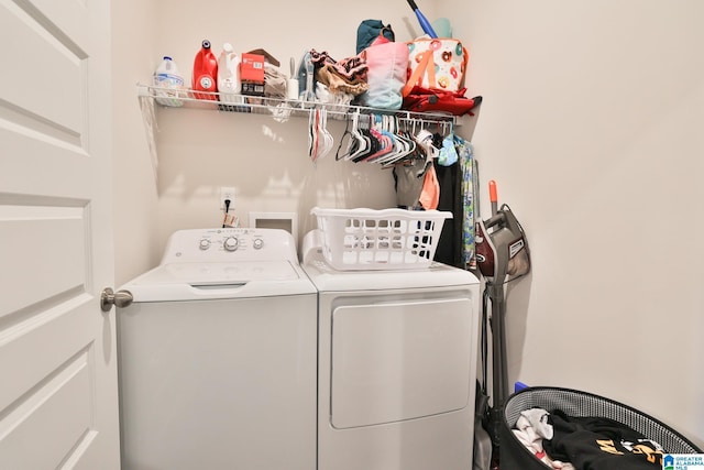 washroom with independent washer and dryer and laundry area
