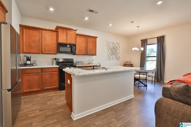 kitchen with dark wood-style flooring, a sink, black appliances, and visible vents