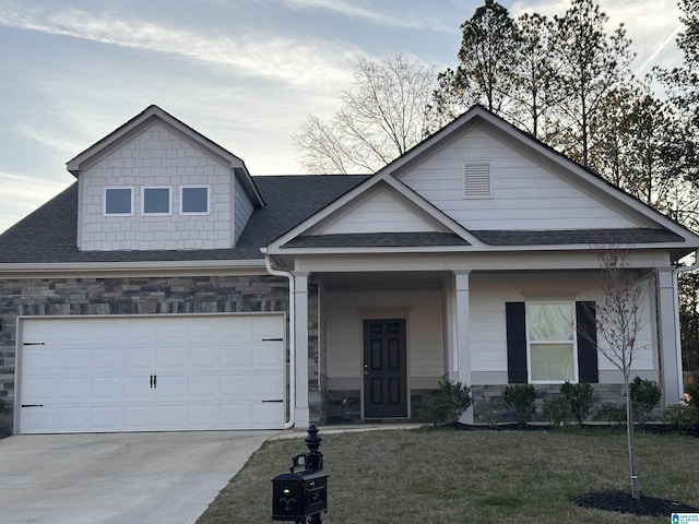 view of front of house featuring driveway, stone siding, a garage, and roof with shingles