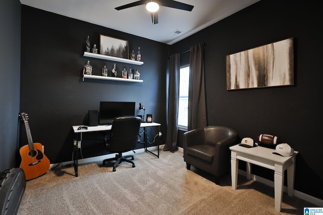 carpeted office featuring baseboards, visible vents, and ceiling fan