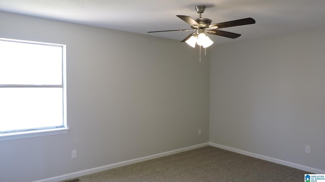 empty room featuring baseboards, carpet flooring, and a ceiling fan
