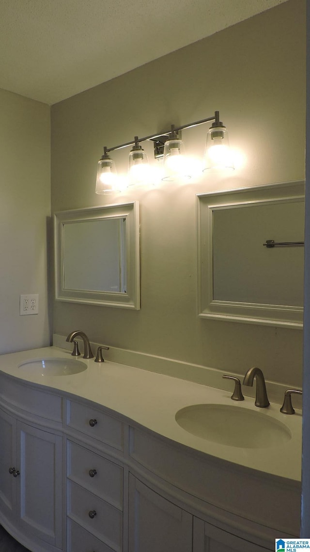 full bathroom featuring double vanity and a sink