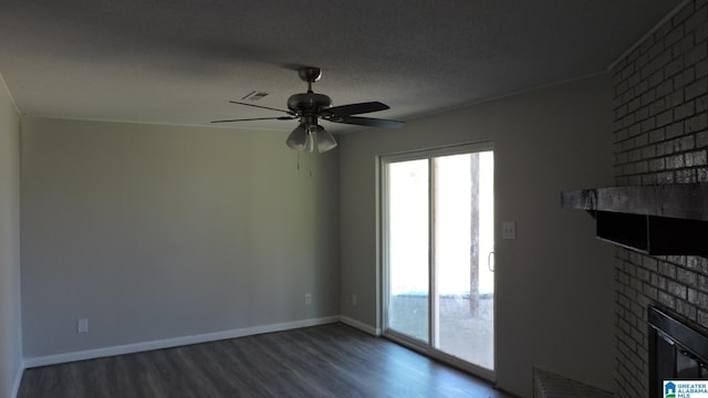 unfurnished living room with a fireplace, wood finished floors, baseboards, visible vents, and ceiling fan