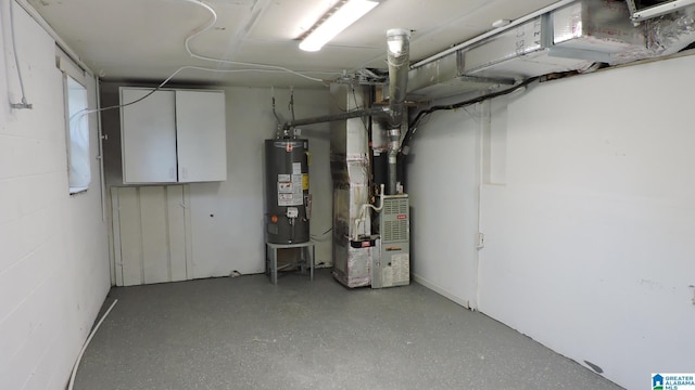 unfinished below grade area with heating unit, concrete block wall, and gas water heater
