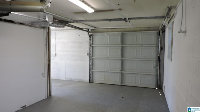 garage with concrete block wall