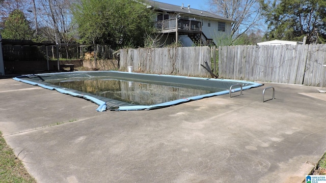 view of swimming pool with a fenced backyard, a patio area, and a fenced in pool