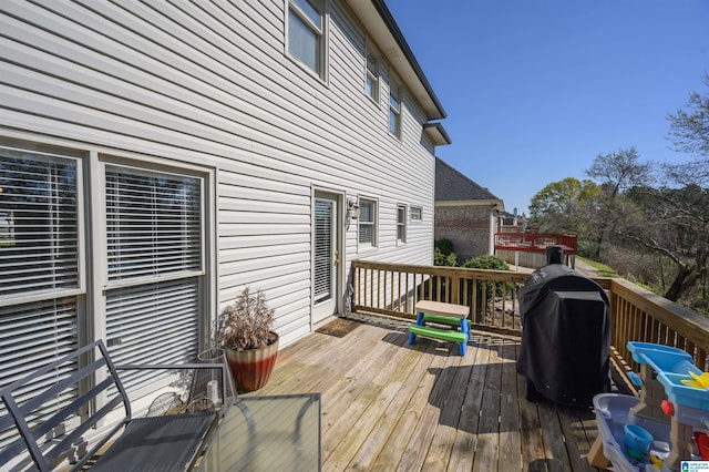 wooden deck with a grill