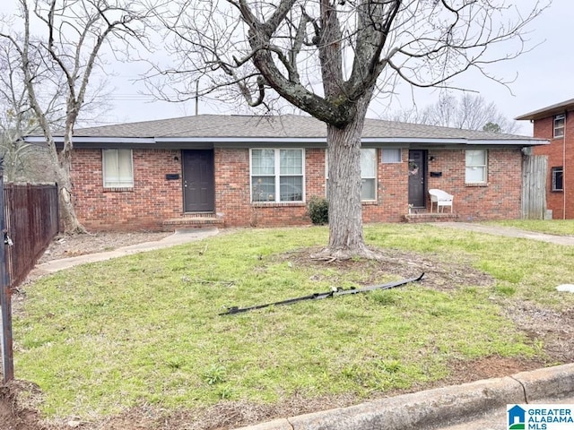 7709 7th Ave S, Birmingham, AL 35206 - single story home featuring a shingled roof, a front yard, fence, and brick siding