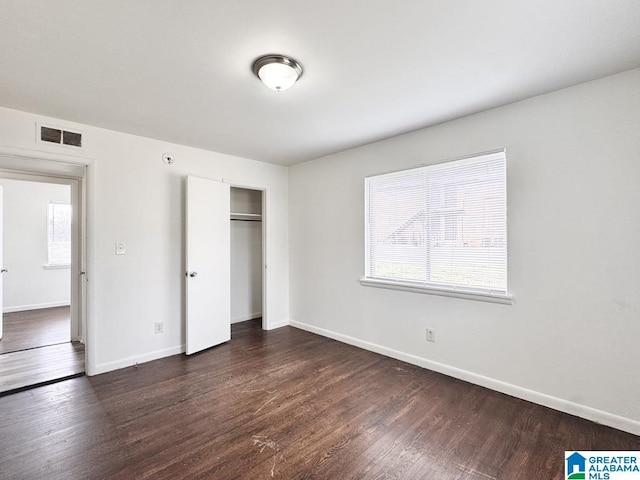 7709 7th Ave S, Birmingham, AL 35206 - unfurnished bedroom with dark wood-style flooring, multiple windows, and visible vents