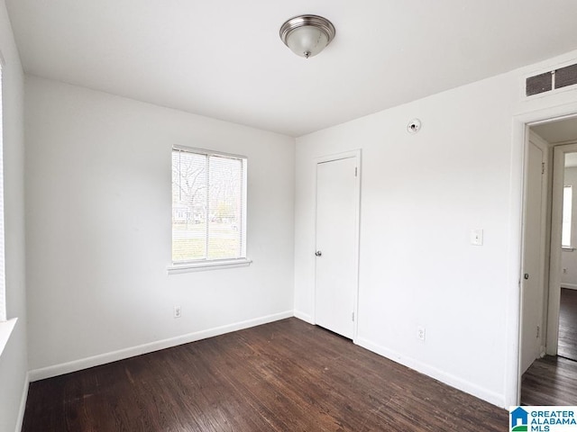 7709 7th Ave S, Birmingham, AL 35206 - empty room featuring baseboards, visible vents, and dark wood-type flooring