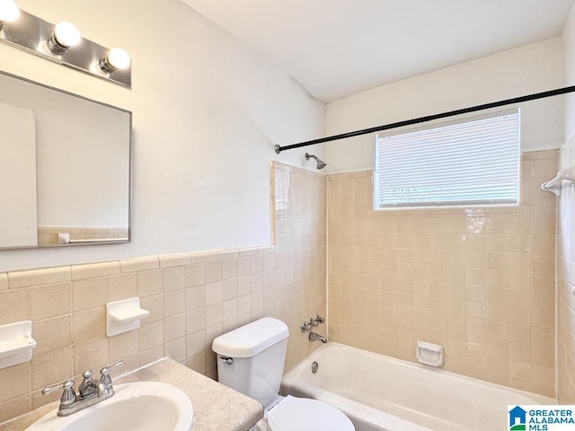 7709 7th Ave S, Birmingham, AL 35206 - bathroom with a wainscoted wall, toilet, vanity, shower / washtub combination, and tile walls
