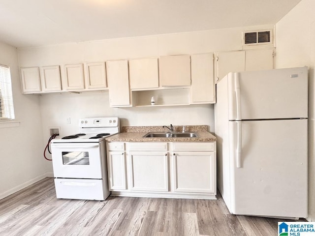 7709 7th Ave S, Birmingham, AL 35206 - kitchen featuring visible vents, light wood-style flooring, white appliances, baseboards, and a sink