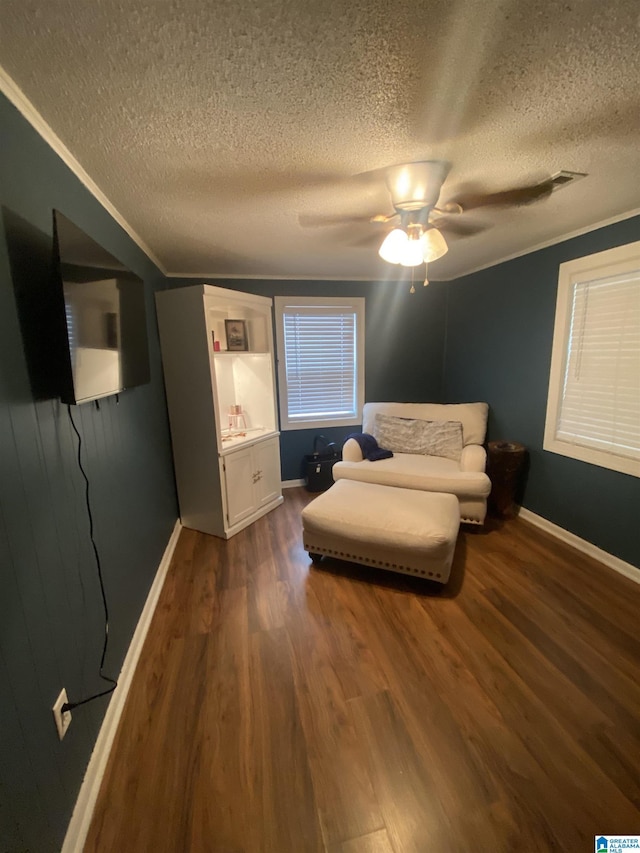 bedroom featuring ornamental molding, dark wood-style floors, baseboards, and ceiling fan