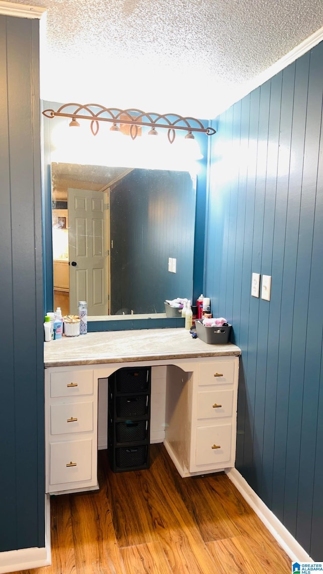 bathroom with a textured ceiling and wood finished floors