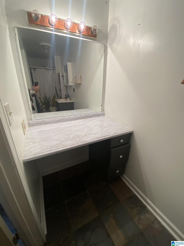 full bathroom featuring toilet, vanity, and baseboards