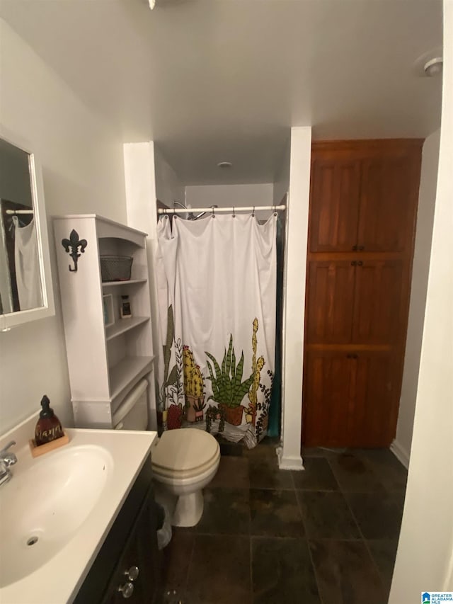 bathroom with toilet, vanity, curtained shower, and tile patterned floors