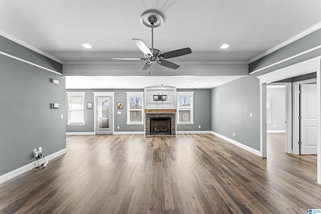 unfurnished living room featuring a fireplace, baseboards, ceiling fan, and wood finished floors