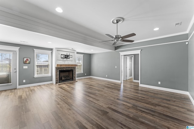 unfurnished living room featuring visible vents, baseboards, and wood finished floors