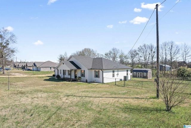 modern farmhouse style home with fence, a front lawn, and roof with shingles