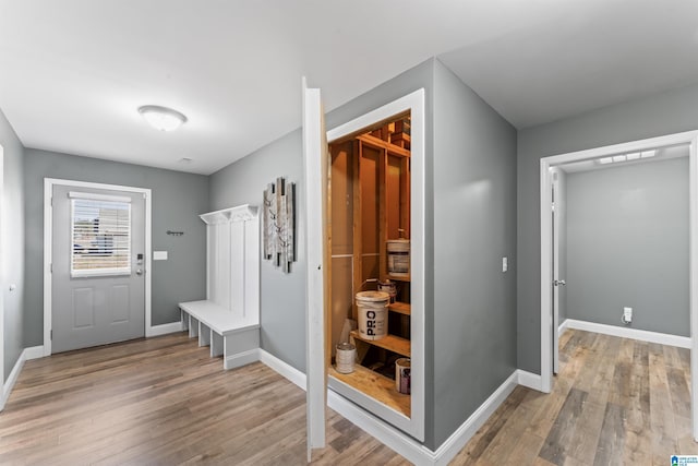 mudroom with baseboards and light wood-style floors